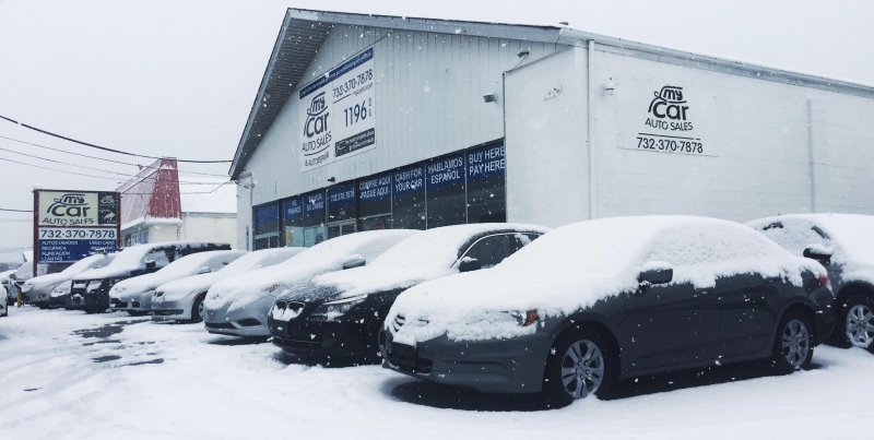 image of cars in dealer lot covered in snow